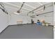 Spacious garage with painted floor, overhead lighting, and ample storage space at 6920 Haven Hollow Ave, Las Vegas, NV 89130