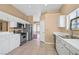 Well-lit kitchen with white cabinets, stainless steel appliances, and tiled flooring at 6920 Haven Hollow Ave, Las Vegas, NV 89130