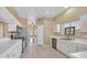 Bright kitchen featuring white cabinets, tiled floors, modern appliances, and ample counter space at 6920 Haven Hollow Ave, Las Vegas, NV 89130