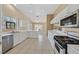 Bright kitchen with white cabinets, tiled floors, modern appliances, and ample counter space at 6920 Haven Hollow Ave, Las Vegas, NV 89130