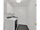 Laundry room featuring a modern washer and dryer set, storage cabinets, and a closed door at 6920 Haven Hollow Ave, Las Vegas, NV 89130