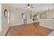 Bright, open-concept living area with hardwood floors flowing into carpet, and views of the kitchen at 6920 Haven Hollow Ave, Las Vegas, NV 89130