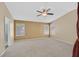 Spacious bedroom featuring vaulted ceilings, neutral carpet, and natural light from large windows at 6920 Haven Hollow Ave, Las Vegas, NV 89130