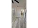 Bright bedroom featuring a closet and bathroom entrances, plus wood grain flooring at 6955 N Durango Dr # 1013, Las Vegas, NV 89149