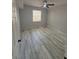 A light and airy bedroom showcasing wood grain flooring, a window, and a ceiling fan at 6955 N Durango Dr # 1013, Las Vegas, NV 89149