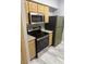 Kitchen featuring matching stainless steel appliances and modern flooring at 6955 N Durango Dr # 1013, Las Vegas, NV 89149