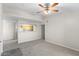 Bright living room with carpet, neutral walls, opening to a kitchen, and a ceiling fan at 6955 N Durango Dr # 2054, Las Vegas, NV 89149