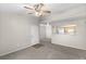 Open-concept living room showcasing neutral paint, carpet flooring, and kitchen pass-through at 6955 N Durango Dr # 2054, Las Vegas, NV 89149
