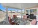 Relaxing covered patio area with outdoor dining set, barbecue and landscaped backyard at 7019 Shadow Crest Dr, Las Vegas, NV 89119