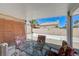 Inviting covered patio with a round dining table set, perfect for outdoor entertaining and relaxation at 7019 Shadow Crest Dr, Las Vegas, NV 89119