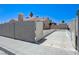 The backyard features block wall fencing, a security gate, and a concrete paved parking area at 7019 Shadow Crest Dr, Las Vegas, NV 89119