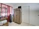 This bedroom features a tall storage cabinet and natural light from the window at 7019 Shadow Crest Dr, Las Vegas, NV 89119