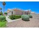Charming home featuring desert landscaping, a two-car garage, and a well manicured front yard at 7019 Shadow Crest Dr, Las Vegas, NV 89119