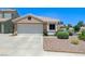 Charming home featuring desert landscaping, a two-car garage, and a well manicured front yard at 7019 Shadow Crest Dr, Las Vegas, NV 89119