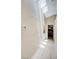 The hallway features sunlight, a thermostat, wood floors and entry to other rooms at 7019 Shadow Crest Dr, Las Vegas, NV 89119