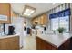 Bright kitchen with wooden cabinets, white countertops, and modern appliances at 7019 Shadow Crest Dr, Las Vegas, NV 89119