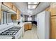Bright kitchen features a stove, white countertops, and plenty of cabinet storage at 7019 Shadow Crest Dr, Las Vegas, NV 89119