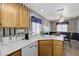 Functional kitchen with white appliances and countertops overlooking a breakfast nook at 7019 Shadow Crest Dr, Las Vegas, NV 89119