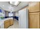 Open-concept kitchen with white appliances, lots of storage, and natural light at 7019 Shadow Crest Dr, Las Vegas, NV 89119