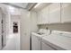 The laundry room features a washer and dryer set in a closet next to a hallway at 7019 Shadow Crest Dr, Las Vegas, NV 89119