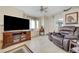 Comfortable living room with natural light, entertainment center, and a plush recliner for relaxation at 7019 Shadow Crest Dr, Las Vegas, NV 89119