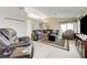 Spacious living room with tile floors, high ceilings, and comfortable seating arrangements at 7019 Shadow Crest Dr, Las Vegas, NV 89119