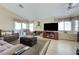 Cozy living room featuring vaulted ceilings, tile floors, a ceiling fan, and comfortable seating at 7019 Shadow Crest Dr, Las Vegas, NV 89119