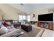 Spacious living room with a fireplace, TV, and comfortable seating, perfect for entertaining at 7019 Shadow Crest Dr, Las Vegas, NV 89119