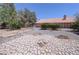Spacious backyard featuring a unique stone pathway and desert landscaping is ready for your enjoyment at 710 Tomahawk Ct, Pahrump, NV 89060