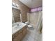 Bathroom featuring a vanity sink, toilet, and bathtub-shower combination with a shower curtain at 710 Tomahawk Ct, Pahrump, NV 89060