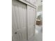 Bathroom doors with a glimpse of the sink, mirror, and wallpaper at 710 Tomahawk Ct, Pahrump, NV 89060
