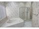 Bright bathroom featuring a jetted tub, a glass-enclosed shower, and elegant wallpaper at 710 Tomahawk Ct, Pahrump, NV 89060