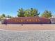 Desert Trails community sign set against a clear blue sky, showcasing a welcoming neighborhood entrance at 710 Tomahawk Ct, Pahrump, NV 89060