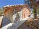 Image showcases the back exterior of a home with a screened in patio and a small fenced area at 710 Tomahawk Ct, Pahrump, NV 89060