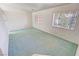 Clean and bright living room featuring neutral walls and plush green carpeting at 710 Tomahawk Ct, Pahrump, NV 89060