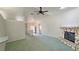 Open-concept living room with stone fireplace and view to kitchen and entryway at 710 Tomahawk Ct, Pahrump, NV 89060
