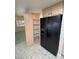 Pantry with shelving, located next to the black refrigerator in the kitchen at 710 Tomahawk Ct, Pahrump, NV 89060