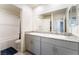 Bright bathroom features double sinks with granite countertop and a shower-tub combination at 7211 Alabaster Peak St, Las Vegas, NV 89166