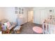 Cozy Bedroom with rocking chair, stylish dresser, and white crib ready for a new baby at 7211 Alabaster Peak St, Las Vegas, NV 89166