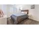 Comfortable bedroom with a wooden bed frame, soft gray bedding, and a convenient nightstand at 7211 Alabaster Peak St, Las Vegas, NV 89166