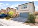 Two-story home featuring a well-maintained front yard, a paved driveway, and an attached garage at 7211 Alabaster Peak St, Las Vegas, NV 89166