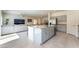 Open-concept kitchen with island and stainless steel appliances adjacent to the living area at 7211 Alabaster Peak St, Las Vegas, NV 89166