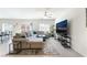 Spacious living room with tile flooring, comfortable sectional sofa, and modern entertainment center at 7211 Alabaster Peak St, Las Vegas, NV 89166