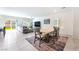 Open-concept living room with adjacent kitchen, tile floors, and access to the backyard through sliding glass doors at 7211 Alabaster Peak St, Las Vegas, NV 89166