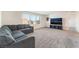 Large living room with neutral carpet, comfortable seating, and plenty of natural light at 7211 Alabaster Peak St, Las Vegas, NV 89166