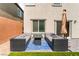 Stylish outdoor patio area with modern seating arrangements and a fire pit table at 7211 Alabaster Peak St, Las Vegas, NV 89166