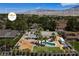 Stunning aerial view of a home with a pool, horse area, and RV parking in a lush, landscaped neighborhood at 7675 Butterscotch Ct, Las Vegas, NV 89131