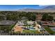 Breathtaking aerial shot of the home with lush landscaping, a pool, RV parking and mountain views at 7675 Butterscotch Ct, Las Vegas, NV 89131