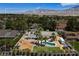 Northwest Las Vegas property featuring an outdoor pool, a horse pen, and mature trees at 7675 Butterscotch Ct, Las Vegas, NV 89131