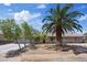 Charming single-story home with a well-manicured front yard, mature landscaping, and a circular driveway at 7675 Butterscotch Ct, Las Vegas, NV 89131